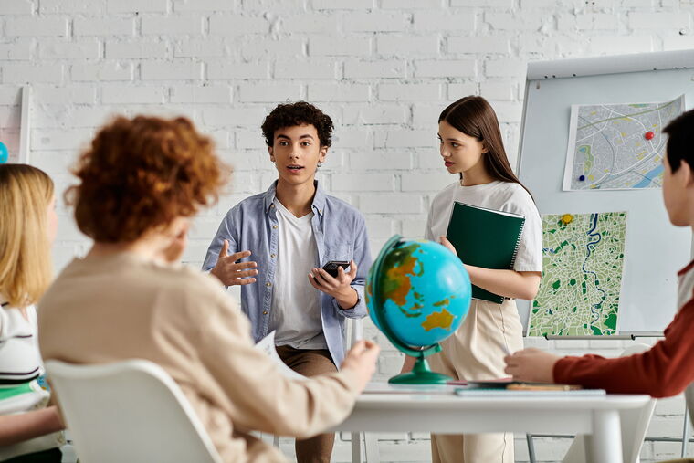 Jugendliche führen eine Diskussion und stehen um einen Tisch versammelt